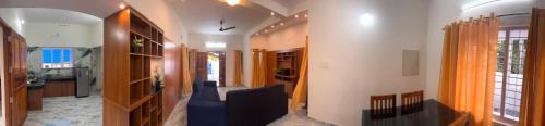 a hallway of a house with a blue couch at MOON 3bhk ENTIRE VILLA 02 Varkala with kitchen in Varkala