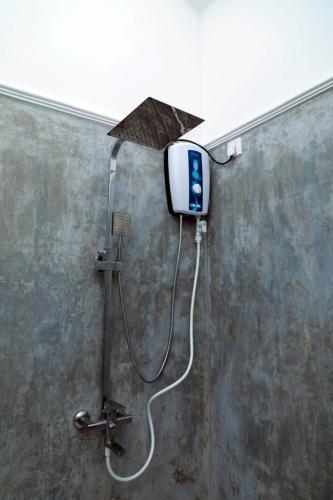 a shower with an umbrella attached to a wall at Green Oasis Ahangama in Ahangama