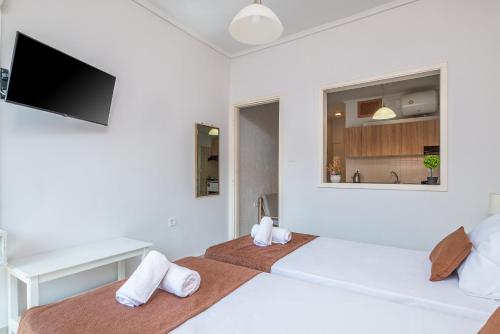 a bedroom with two beds and a flat screen tv at Silia apartments 3 in Ampavris
