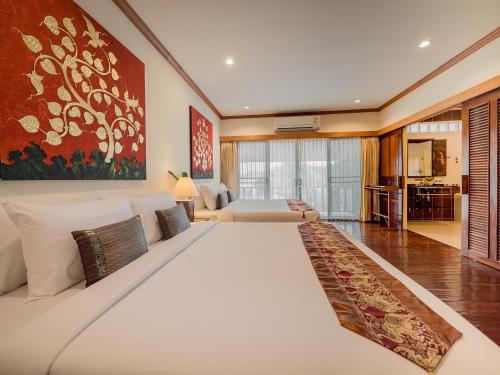 a large white bed in a large room at Chiangkhan River Mountain Resort in Chiang Khan