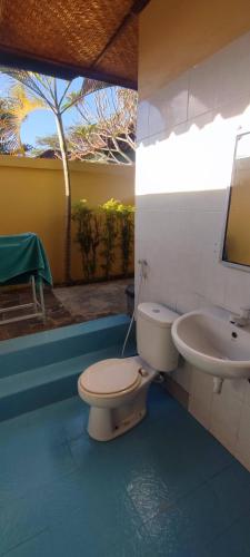 a bathroom with a toilet and a sink at Secret Garden Bungalows in Nusa Lembongan