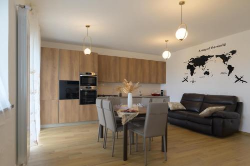 a living room with a table and a couch at La MaGia del Tramonto in Salerno