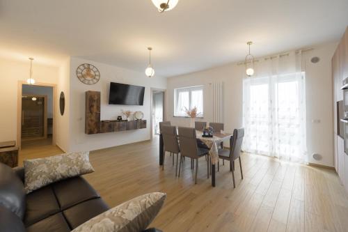 a living room and dining room with a table and chairs at La MaGia del Tramonto in Salerno