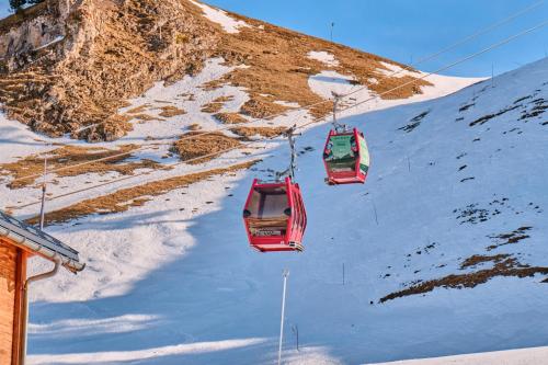 two ski lifts going down a snow covered mountain at Les Myrtilles in Chamrousse