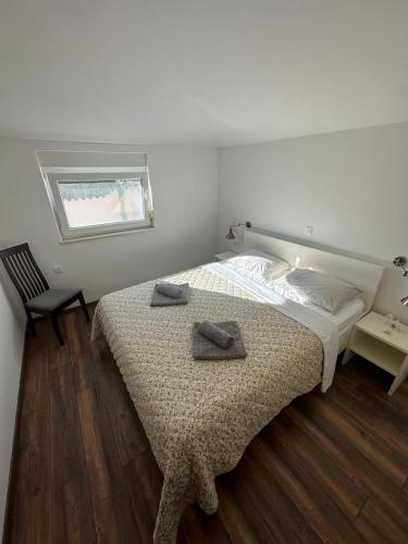 a bedroom with a bed with two towels on it at Apartman Surya Medulin in Medulin
