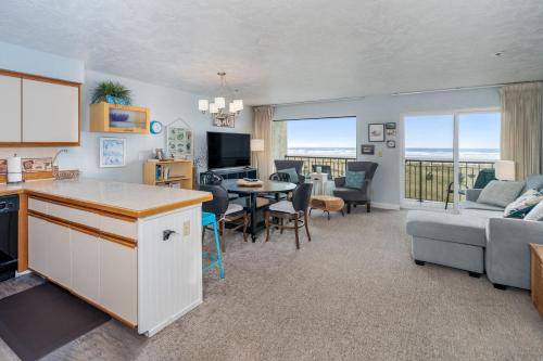 a kitchen and living room with a couch and a table at Seaside Beach Club 203 in Seaside