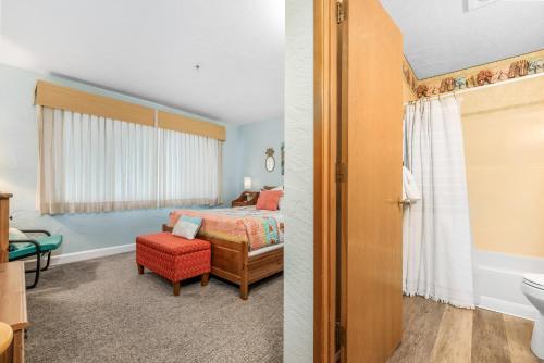 a bedroom with a bed and a bathroom at Seaside Beach Club 203 in Seaside