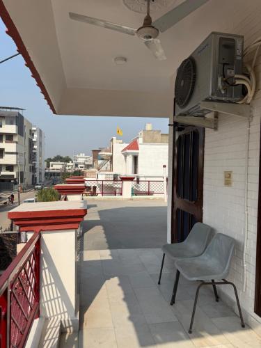 a chair sitting on the balcony of a house at Bienvenue Homestay in Panchkula