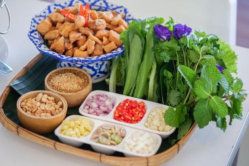 a tray filled with different types of food on a table at Chiangkhan River Mountain Resort in Chiang Khan