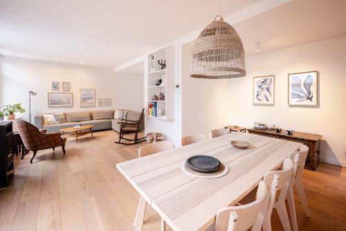 a living room with a table and a couch at Beautiful Beach Holiday Home with Sauna and Garden in Wijk aan Zee
