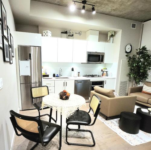 a kitchen and living room with a table and chairs at Luxurious Downtown condo with spectacular views in Calgary