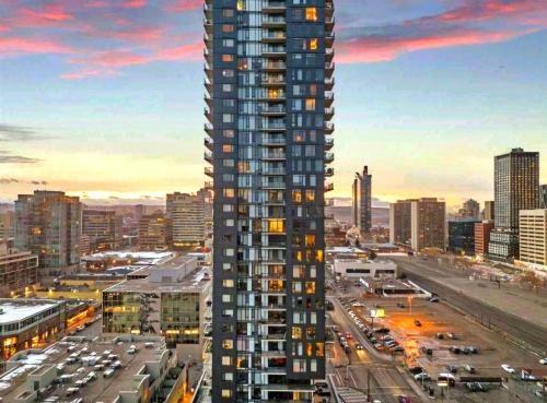 a rendering of a tall building in a city at Luxurious Downtown condo with spectacular views in Calgary
