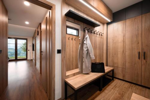 a hallway with wood paneling and a bench in a house at BARTH Holiday - Říčky v Orlických horách in Říčky