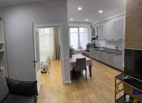 a kitchen with a table and a dining room at Park House Apartment in Chişinău