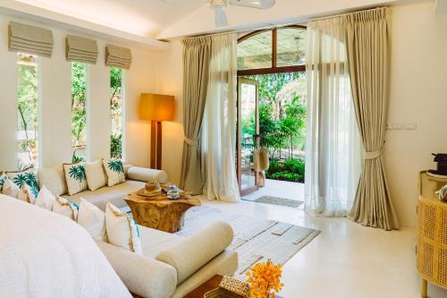 a living room with a couch and a table at Zazen Boutique Resort & Spa in Bophut