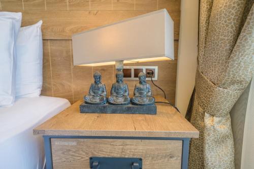 a nightstand with a lamp on it next to a bed at Aurasia Beach Hotel in Marmaris