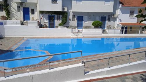 a large swimming pool with blue water at Eleor in Siviri