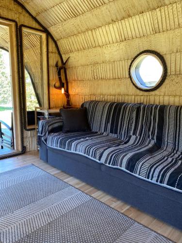 a large bed in a room with a mirror at JES Kalana Beachhouse in Kalana