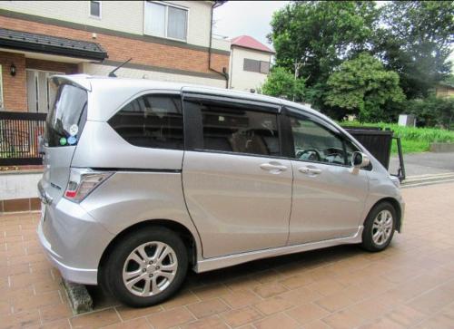 a small silver van parked in a driveway at Ryokan Gallery Tokyo in Kamagaya