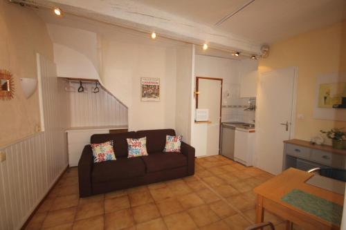 un salon avec un canapé et une cuisine dans l'établissement Treille 1 1er étage, à Collioure