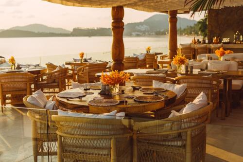a restaurant with tables and chairs with a view of the ocean at Zazen Boutique Resort & Spa in Bophut 