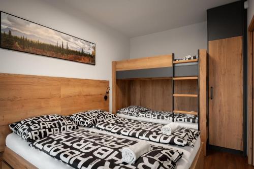 two beds in a bedroom with a bunk bed at BARTH Holiday - Říčky v Orlických horách in Říčky