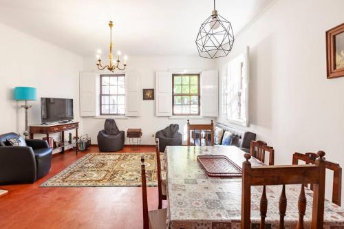 a large living room with a table and chairs at Casa da Avó Zilda in Guimarães