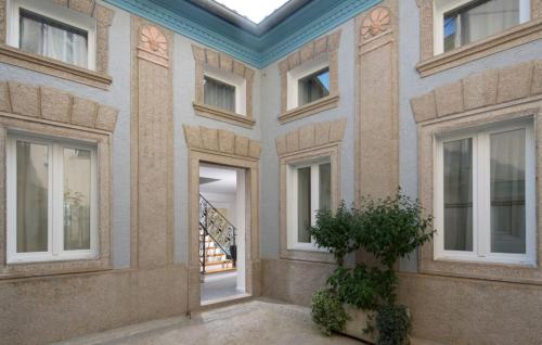 a building with a door and a potted plant at Beautiful Villa Palazzo Adriana Krk in Dobrinj