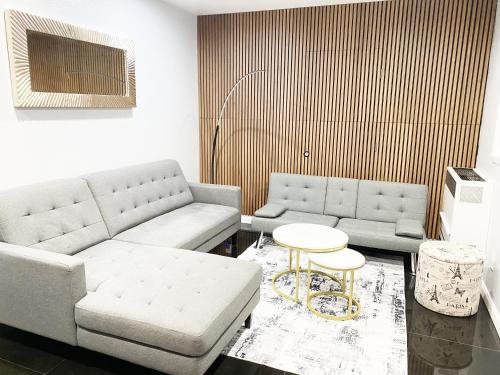 a living room with two couches and a table at Victorian Retreat 2Bed, 1Bath, Parking, Game Room in Oakland