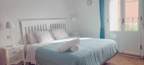 a bedroom with a bed with a towel on it at Casa Filo - Country house near la Cruz de Piedra in Plasenzuela