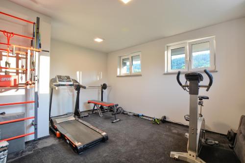 a gym with two tread machines in a room at Apartament Szczęśliwy in Ustrzyki Dolne