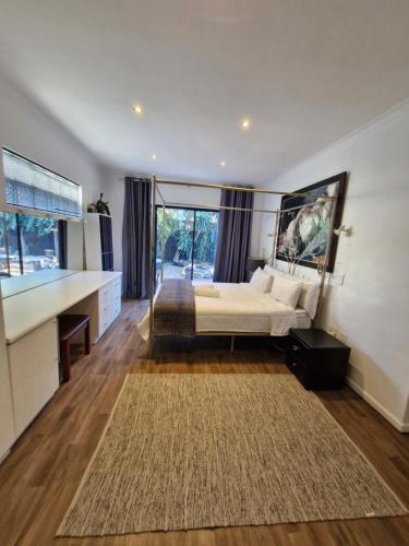 a bedroom with a bed and a large window at Regent Casa's - Cape Towns Blouberg Area - Where 20 people can stay in Cape Town