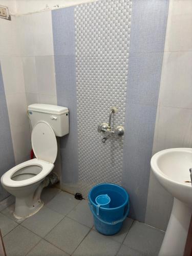 a bathroom with a toilet and a sink at Shahgul's Service Apartments in Hyderabad