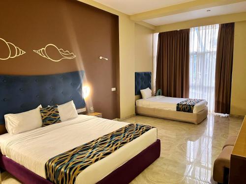 Postel nebo postele na pokoji v ubytování Aryana Queen Beach Resort