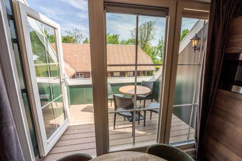 a view of a balcony with a table and chairs at Appartementen De Witte Brugh in Buren