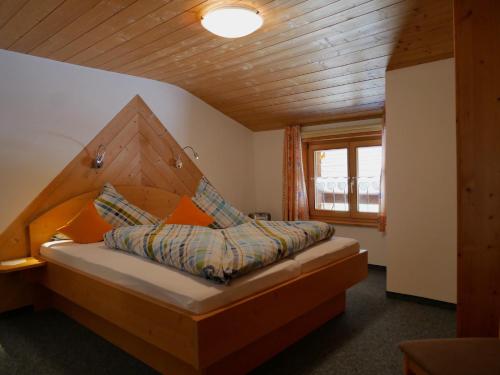 a bedroom with a bed with a wooden headboard at Haus Edelweiß in Bad Hindelang