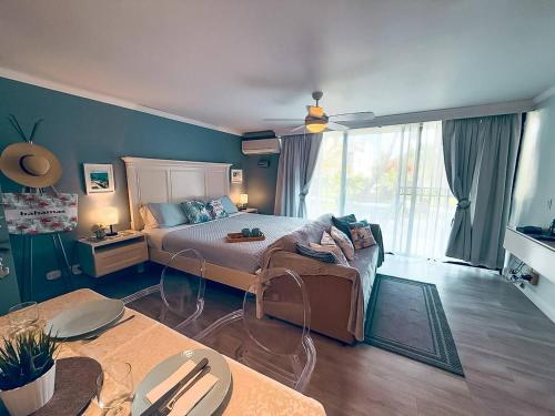 a bedroom with a bed and a large window at NEW Stunning Beachfront Condo at the Coral Beach in Freeport