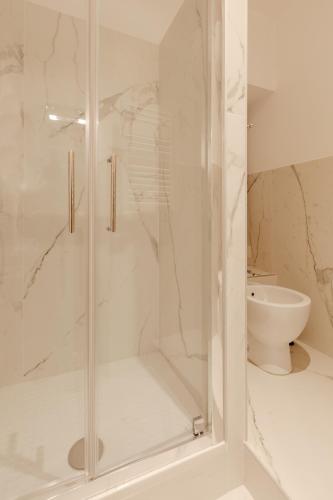 a shower with a glass door in a bathroom at Happy Home in Rome