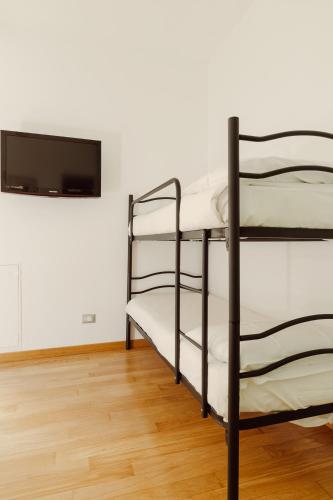 a room with two bunk beds and a flat screen tv at Happy Home in Rome