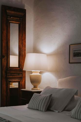 a lamp sitting on a table next to a bed at Studios Kilindra in Astypalaia Town
