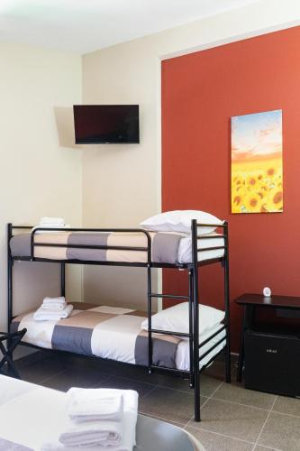 two bunk beds in a room with a flat screen tv at SANBARTO LA CASA DEL BORGO in Cassano Irpino