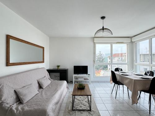 un salon avec un canapé et une table dans l'établissement casa Lyon Appartement lumineaux, à Lyon