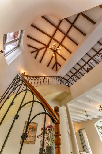 a spiral staircase with a coffered ceiling at Villa Lluvia 5bhk-Huge Pvt Pool-Caretaker-Bathtub-Big Garden-Genset Backup- Siolim in Oxel
