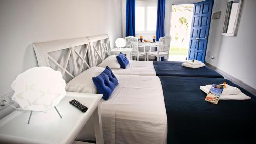 a bedroom with two beds with blue and white at Corralejo Lodge in Corralejo