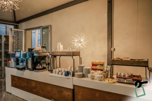 a kitchen with a counter with plates and cups at HOTIDAY Room Collection - Porto Venere in Portovenere