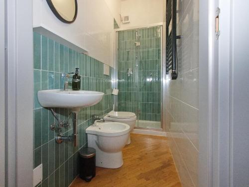 a bathroom with a toilet and a sink and a shower at Aurora Rooms in Parma