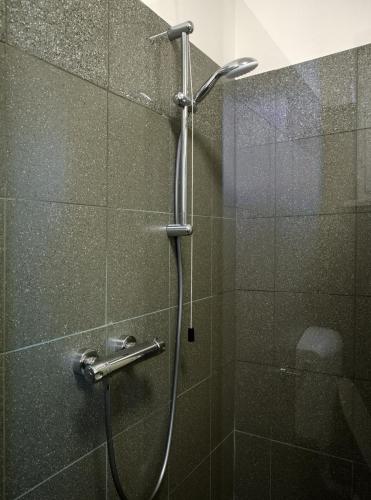 a shower with a glass door in a bathroom at Aurora Rooms in Parma