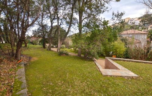 a park with a bench in the grass at 2 Bedroom Beautiful Home In Oletta in Oletta