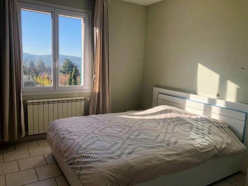 une chambre avec un lit et une grande fenêtre dans l'établissement Sunset Ridge house, à Pierrevert