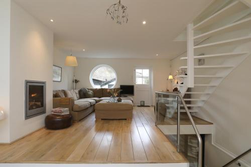 a living room with a couch and a staircase at Gwendolynn lovely holiday home in Bergen